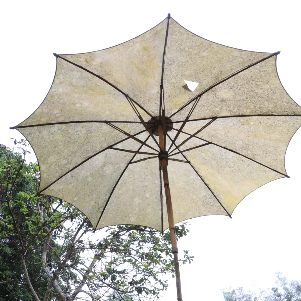 A parasol with torn fabric