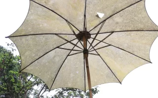 A parasol with torn fabric