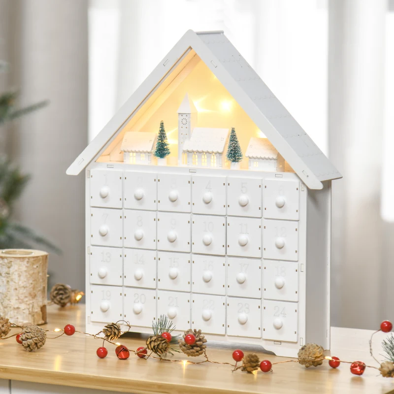 White wooden advent calendar house with glowing village scene.