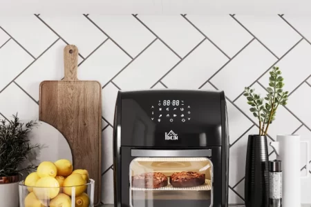 Modern air fryers and mini ovens on kitchen counter promoting healthy cooking discounts.