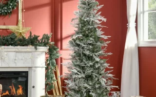 Artificial Christmas tree beside fireplace with red wall and wrapped presents under it.