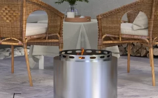 Modern patio with stainless-steel fire pit and rattan chairs.