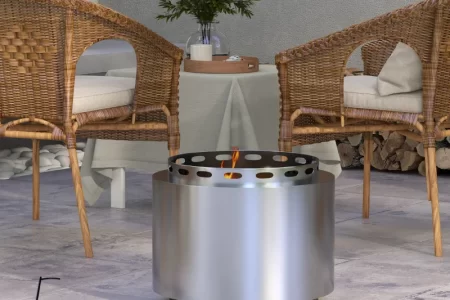 Modern patio with stainless-steel fire pit and rattan chairs.