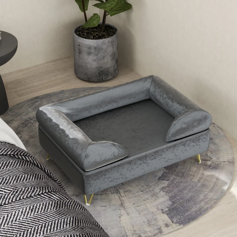 Small grey dog bed placed beside bed in modern room