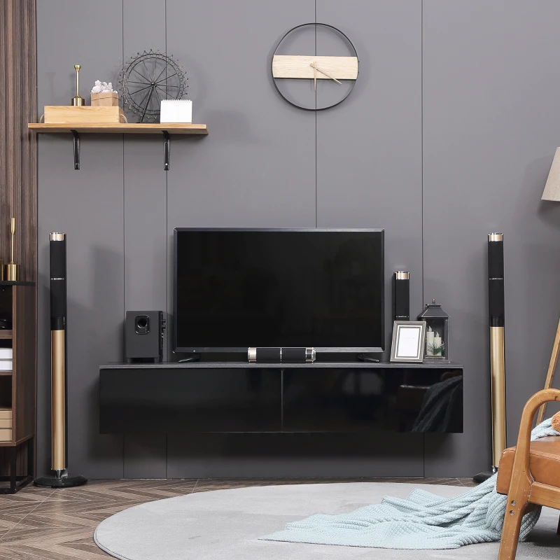 Black glossy floating TV stand with mounted screen and speakers