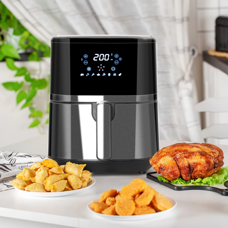 Digital black air fryer with LED screen on counter surrounded by fried snacks and chicken.
