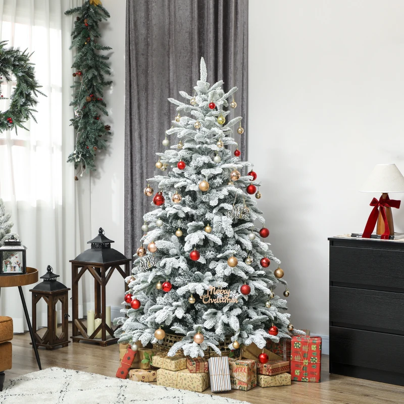 Large flocked Christmas tree decorated with red and gold ornaments