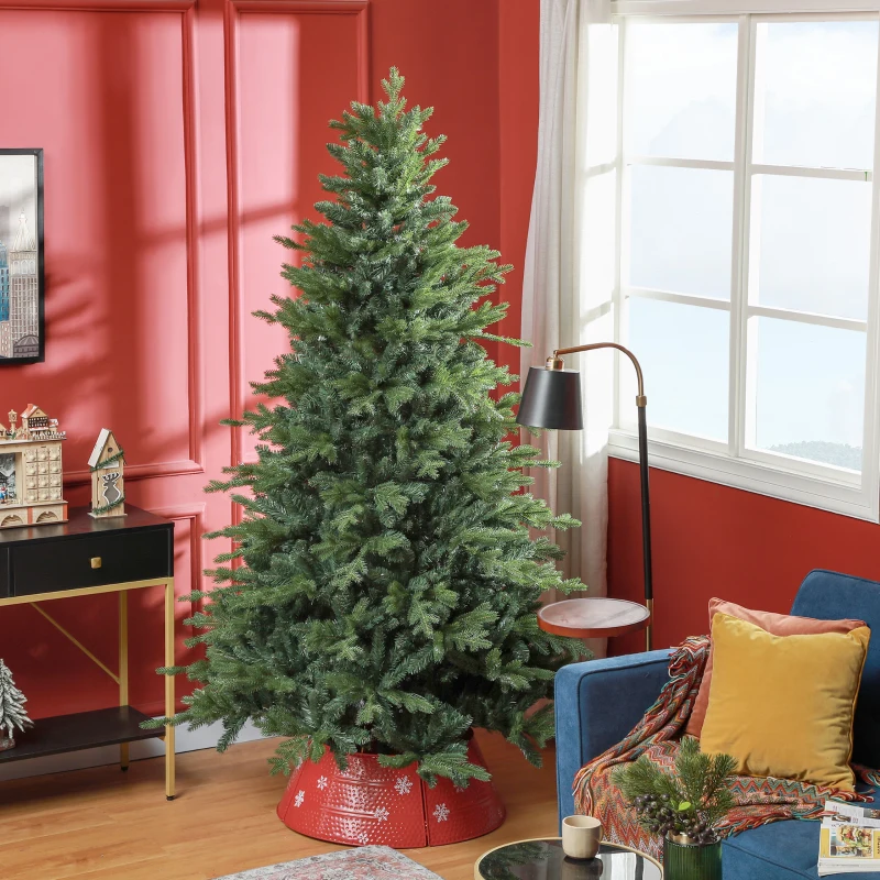 Full green artificial Christmas tree in red-walled living room beside chair and gifts
