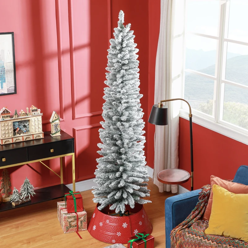 Snowy slim Christmas tree in red living room corner.