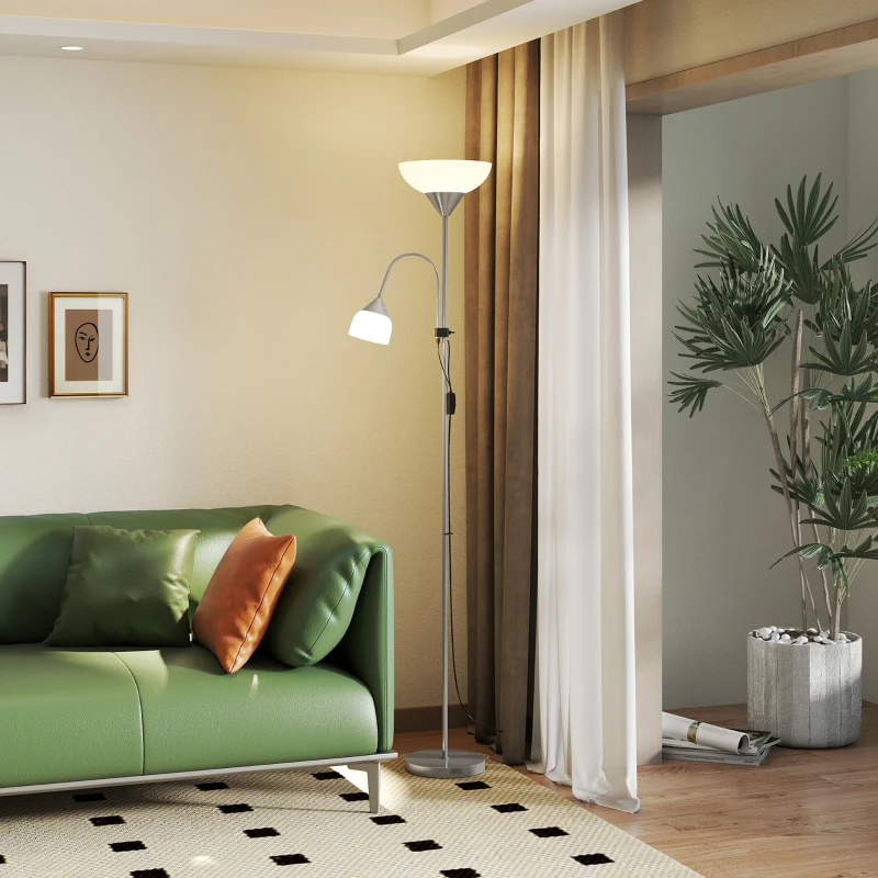 Silver floor lamp with dual lights near a green sofa in a bright living room.