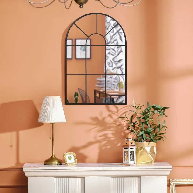 Arched wall mirror with black grid frame on peach wall