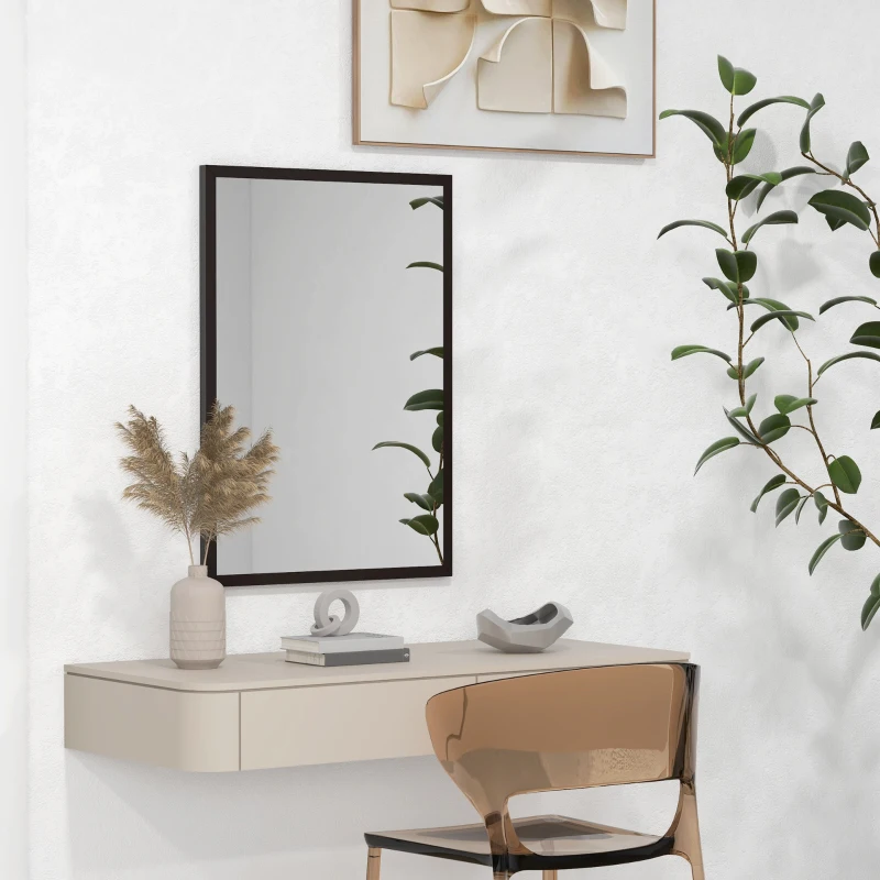 Rectangular wall mirror with black frame above small desk area