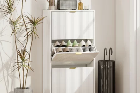 Modern white shoe cabinet with gold accents and organized footwear display.