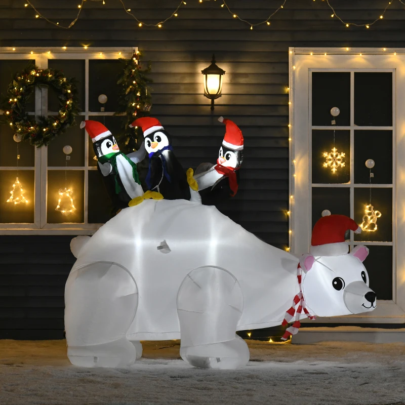 Three penguins riding inflatable polar bear in snowy yard