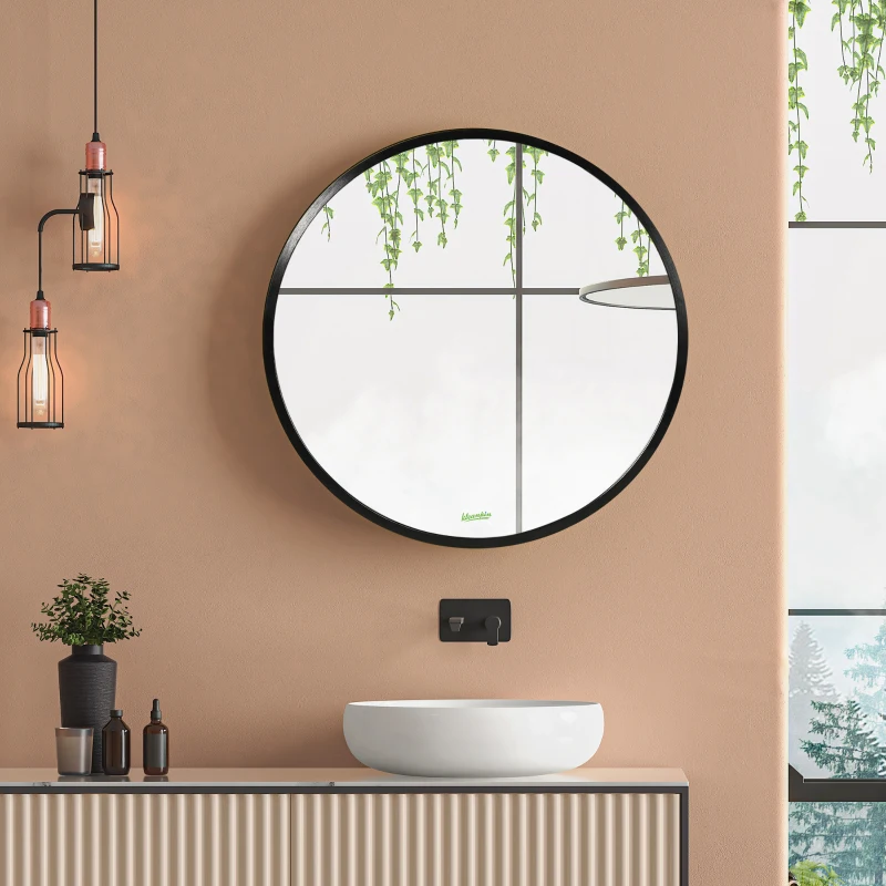 Round wall mirror with black frame above vanity in warm-toned bathroom