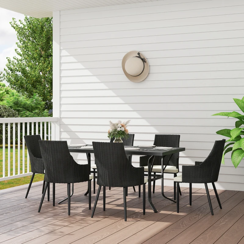 Outdoor black rattan dining table with six cushioned chairs on wooden deck.
