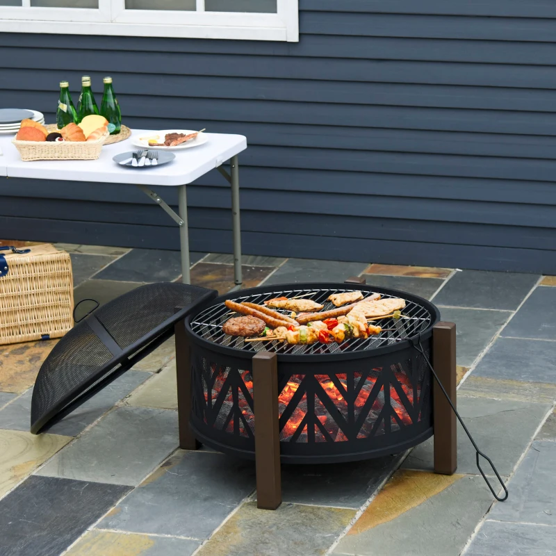 Outdoor grill with skewers and meat cooking on open fire pit.