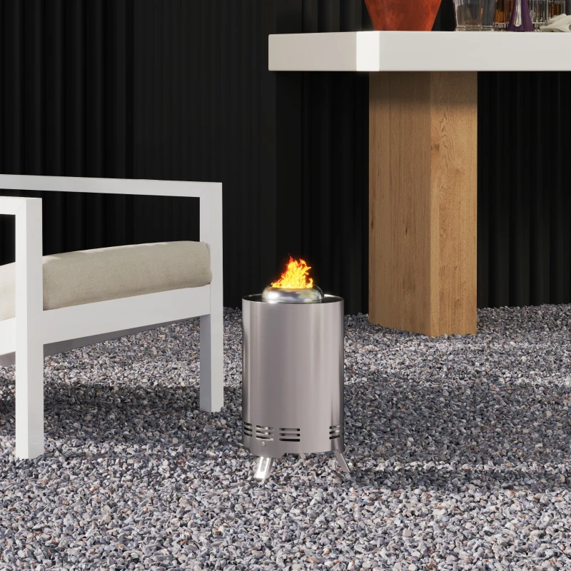 Compact smokeless fire pit on gravel patio near outdoor seating.