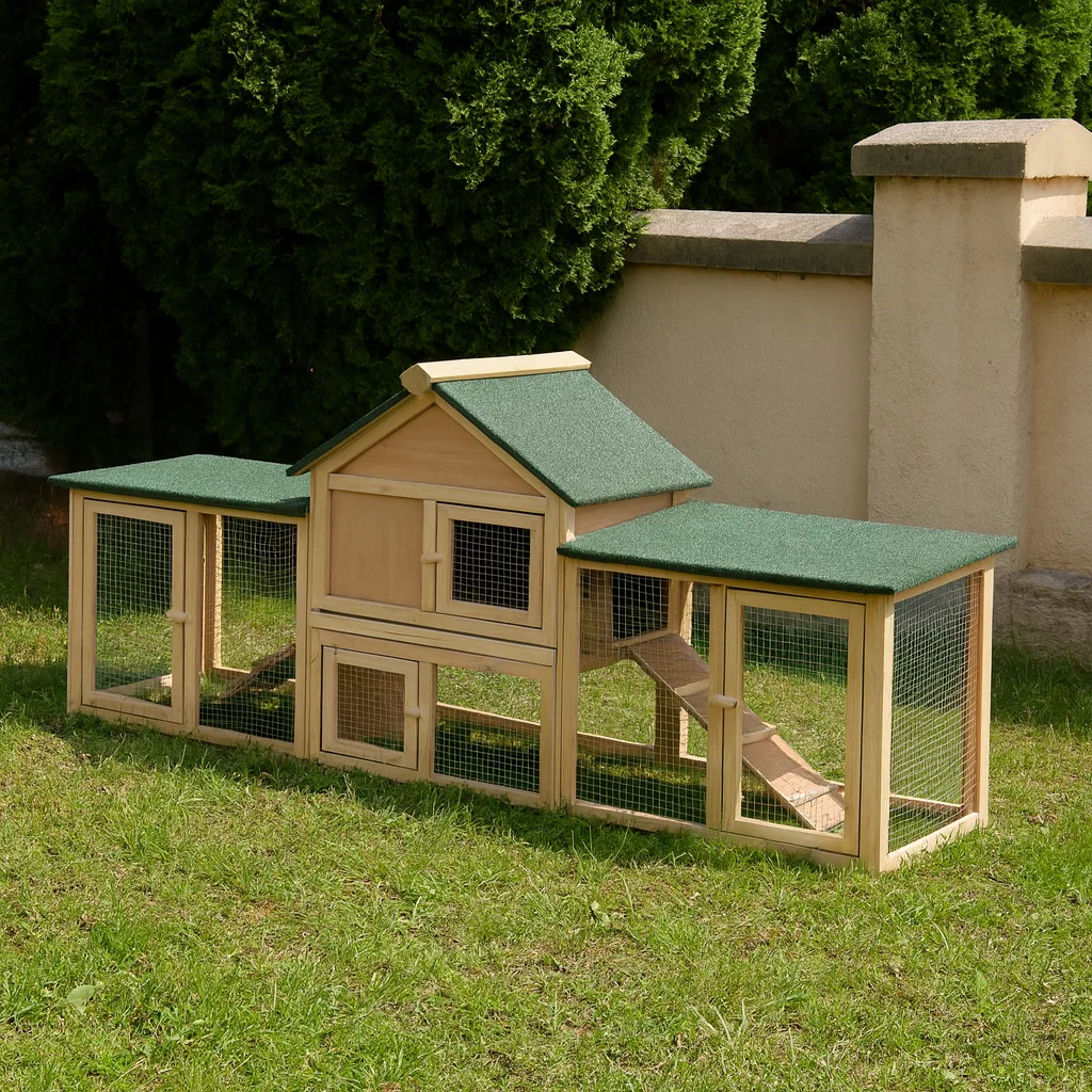 Wooden rabbit hutch with enclosed house and extended mesh runs on grass garden.
