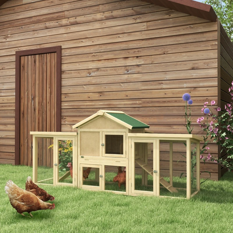 Multi-level wooden chicken house with side run and hens roaming outside.
