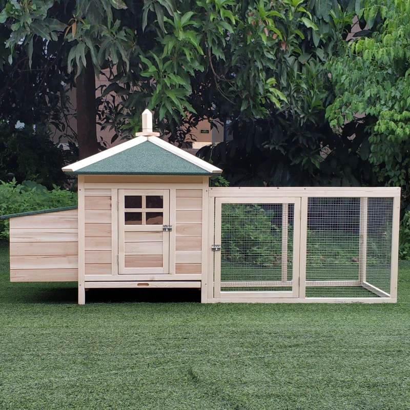 Wooden chicken coop with enclosed run and hens standing near mesh panels.
