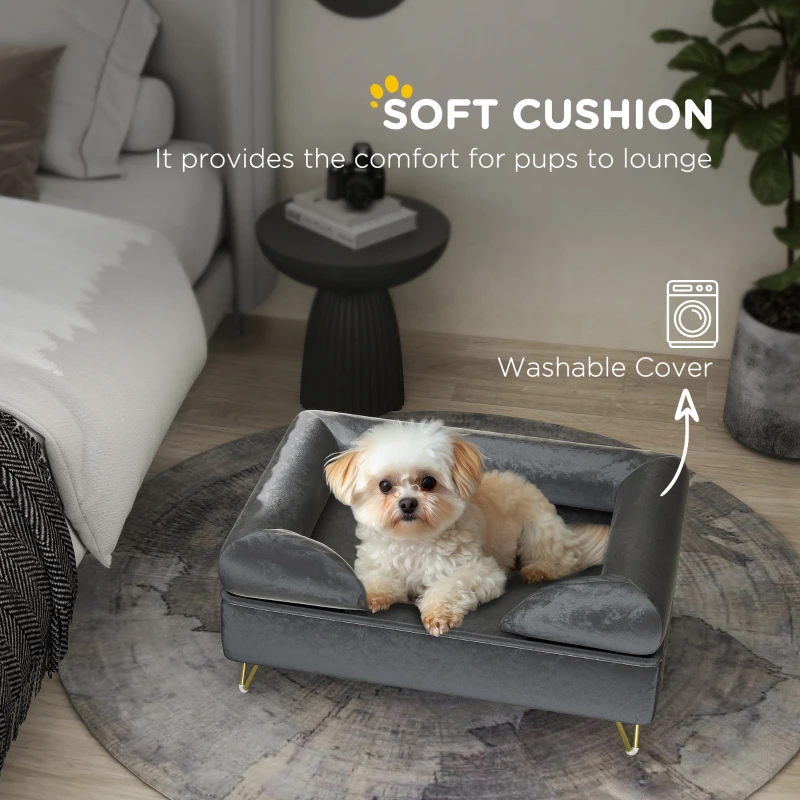 Dod sitted on a dark gray dog bed in a bedroom. 