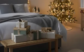 Cosy bedroom with Christmas tree and wrapped gifts