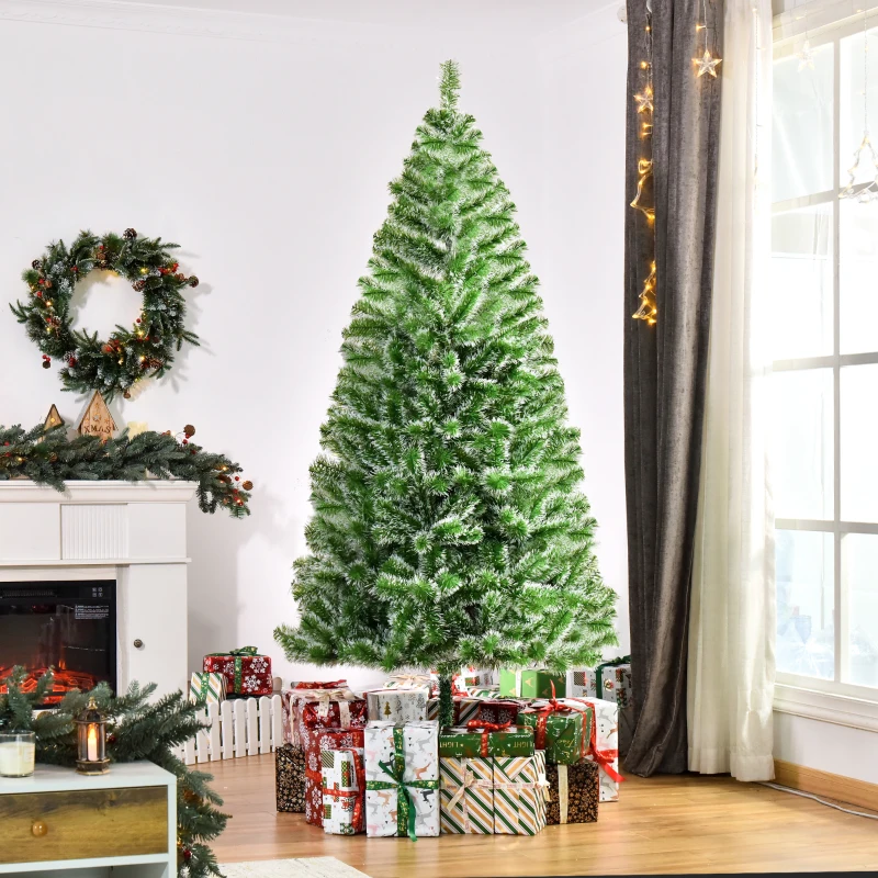Green artificial Christmas tree with snowy tips indoors.