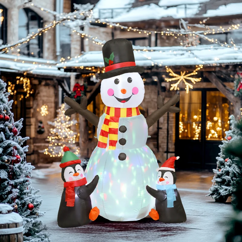 Tall inflatable snowman with penguins in snowy decorated street.