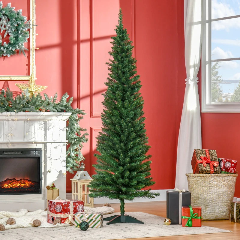 Slim artificial Christmas tree standing beside fireplace decor.