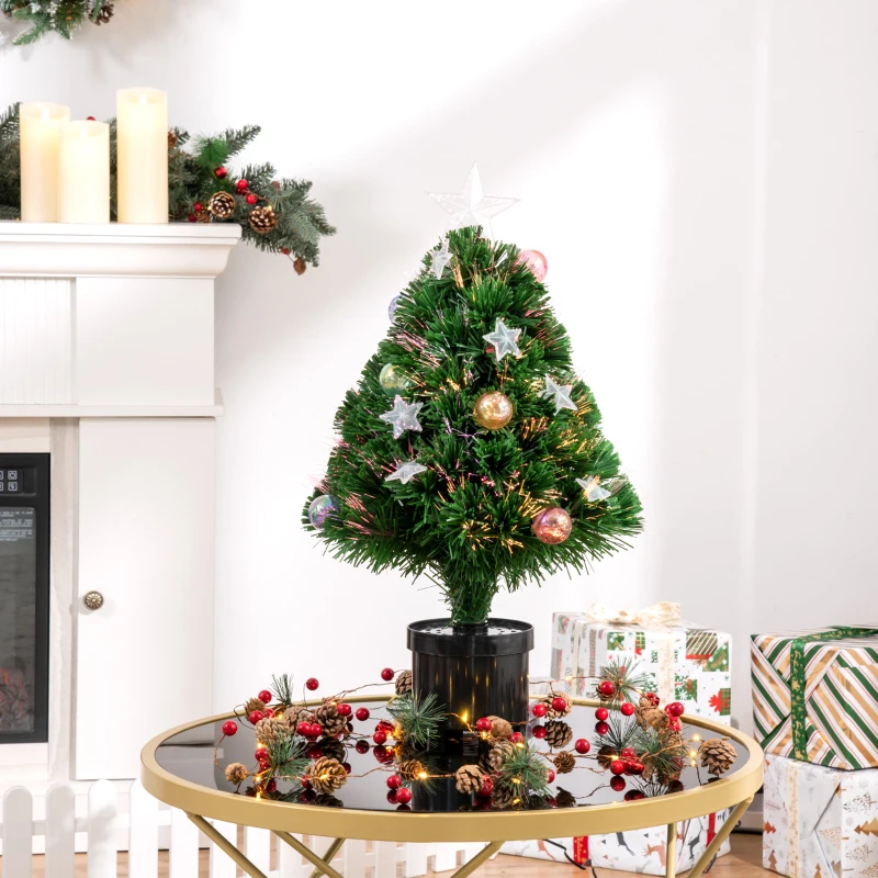 Small decorated tabletop Christmas tree on round table.